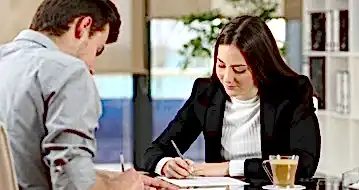 A business owner reviews a document with a client.