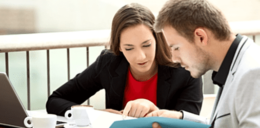 Two business people comparing insurance policies.
