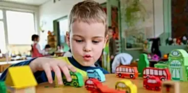 Child playing with toys in a daycare center.