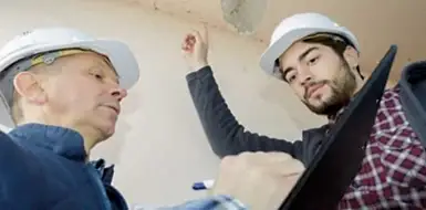 Construction workers discussing a document