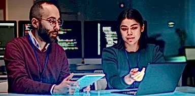 Cybersecurity experts discussing over a computer