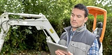 Landscaper filling out contract on clipboard.