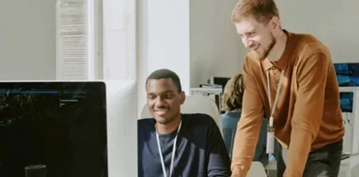 Two cybersecurity specialists performing pen testing for a small business.