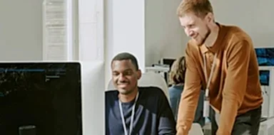Two cybersecurity specialists performing pen testing for a small business.