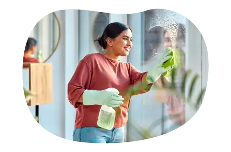 House cleaner washing a client's windows.