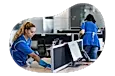 Janitorial professionals cleaning office desks.