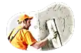 Contractor smoothing plaster onto a building.