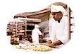 Baker preparing dough in a kitchen.
