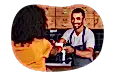 Barista handing a cup of coffee to a customer.