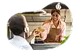 A food trailer business owner hands a customer their order