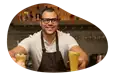 A mobile bartender hands drinks to customers.