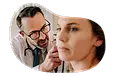 Audiologist examining a patient's ear.