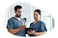 Nurse reviewing a medical chart with a colleague.
