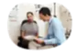 Optometrist reviewing paperwork with a patient.