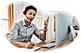 Virtual assistant taking a call from a customer while typing on a laptop.