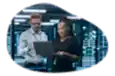 Two employees at a cloud computing company working on a laptop.