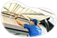A contractor installs an awning on a customer's home.