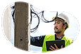 A cable installer working on a utility pole.