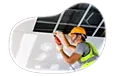 Contractor installing ceiling tiles in a building.