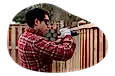 Contractor installing a fence in a yard.