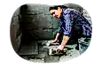 Contractor installing stone tiles in a building.