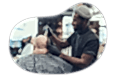 Barber styling a client's hair.