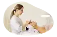Esthetician treating a client's face.