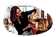 Hairy stylist trimming a client's hair.