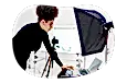 Photographer reviewing photos on a laptop in a studio.