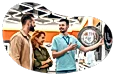 An employee at an appliance store shows off a dryer to customers.