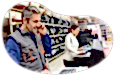 Auto supply store employees working on computers at a store counter.