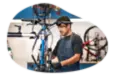 A worker at a bike store assembles a bike.