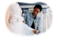 Bridal shop employee measuring a client wearing a wedding dress.