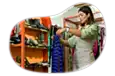 Thrift store employee hanging up new donations on a rack.