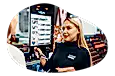 Beauty product salesperson showing accessories on display to a customer.