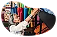 The owner of a fabric store examines a bolt of fabric.