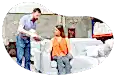 Furniture store employee showing different options on a tablet to a customer on a couch.