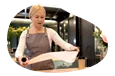 An employee at a gift shop prepares to wrap a gift.