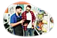 An employee helps a customer find the right item at a hardware store.