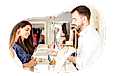 Jewelry store employee helping a customer try on rings.