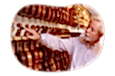 Music store employee scanning through a shelf holding violins.
