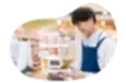 A cashier at a pharmacy rings up an order at a counter.