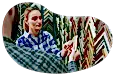 A salesperson shows a customer a frame sample.