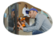 A vending machine operator working on a machine.