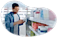 A shopper examines a product in a vitamin store.