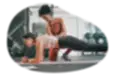 Athletic trainer coaching a client in a gym.