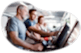 Fitness center employee helping a client on a treadmill.