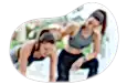 Personal trainer helping a client in a fitness center.