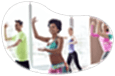 Zumba instructor guiding a class through a routine in a studio.